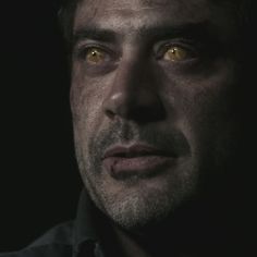 a man with yellow eyes looking at the camera