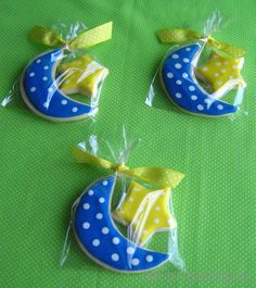 three decorated cookies sitting on top of a green table