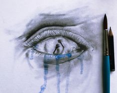 a pencil drawing of an eye with blue streaks on it and a black pen next to it