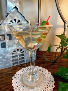 a glass filled with liquid sitting on top of a wooden table