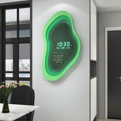 a green clock mounted to the side of a wall next to a dining room table