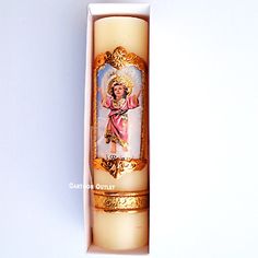 an open candle in a white box with gold trimmings on the front and sides