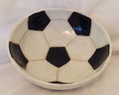 a black and white bowl with a soccer ball on it