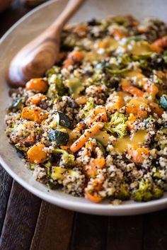 a bowl filled with broccoli, carrots and other food