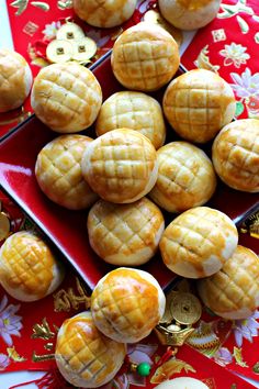 chinese moon cakes on a red plate with gold decorations