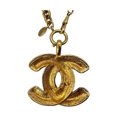 We are offering this rare Chanel Vintage Quilted CC Pendant Necklace. From the 1970 collection by Gabrielle 'Coco' Chanel, this piece is finely crafted of gold-tone hardware and features a lengthy necklace with the classic 'CC' logo pendant in a quilt-engraved appearance. Vintage Gold Necklace With Gold-tone Logo Plaque, Luxury Gold-plated Jewelry With Gold-tone Logo, Vintage Jewelry With Gold-tone Logo Plaque, Vintage Yellow Gold Jewelry With Logo Charm, Vintage Necklace With Logo Charm For Formal Occasions, Luxury Gold Jewelry With Gold-tone Logo Plaque, Designer Gold Brass Jewelry, Gold Jewelry With Logo Charm For Collectors, Vintage Gold-tone Jewelry With Logo Charm