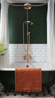 a bathtub with an orange towel hanging from it's side