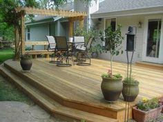 a wooden deck with potted plants on it