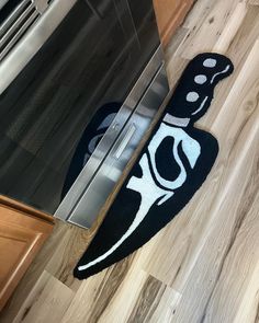 a black and white rug on the floor next to an oven