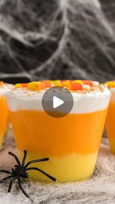 three halloween dessert cups with candy in them