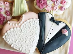 wedding cookies are arranged in the shape of a bride and groom's tuxedo