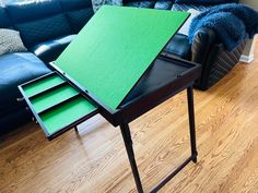 a living room with a couch and a green table