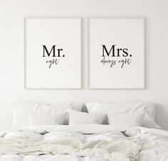 two prints on the wall above a bed with pillows and blankets, one is mr and mrs