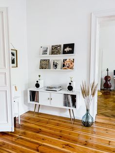 a room with white walls and wooden floors