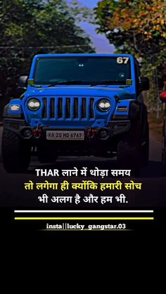 a blue jeep driving down a street next to trees