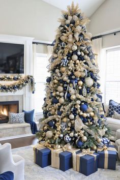 a blue and gold christmas tree in a living room