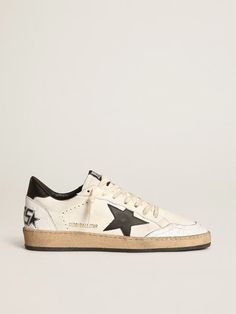 Golden Goose Ball Star Sneaker White Leather/Black sz 39 New in Box Dreaming of the Eighties. Our Ball Star sneakers have an American college vibe caught between a hoop shot and a skateboard ride. This women’s model with a white nappa leather upper accentuated by white crackle leather inserts features a black leather star and heel tab. And the cream-colored laces add the finishing touch: beautiful things that never go out of fashion. White nappa leather upper Black leather star Black leather heel tab White crackle leather insert on the back White crackle leather toe Cream-colored laces Vintage finish Upper: 74% sheepskin leather, 26% cow leather Lining: 58% cow leather, 27% cotton, 12% polyester, 3% textile polyurethane Sole: 100% rubber Made in Italy Handmade Retail: $565 Please ask all q Golden Family, Sneakers Street Style, Exclusive Sneakers, Golden Goose Deluxe Brand, Star Sneakers, Black Leather Heels, Silver Heels, Super Star, Footwear Design Women