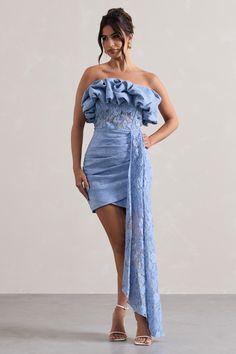 Look out of this world this wedding season in our Neptune, our aptly-named mini dress. Designed in a soft blue shade of our premium crepe, this figure-hugging piece has been carefully wrapped in a delicate lace overlay and features a ruffled neckline, boned bodice and elegantly gathered skirt. Complete with a free flowing drape, whats not to love with Neptune? Features - Premium stretch crepe - Lace overlay- Ruffled bandeau neckline - Boned bodice- Invisible zip closure- Gathered skirt- Floor-length drape- Mini length Sizing & Fit Model is 5'7 and wears UK size 8 / US size 4Product Information Designed exclusively by Club L London Partially layered with good stretch Premium crepe & lace in Blue (47% Polyamide, 36% Cotton, 17% Viscose) Lining (96% Polyester, 4% Elastane)85cm total dress len Dress With Drape, Ruffled Mini Dress, Boned Bodice, Black Dress Prom, Lace Strapless, Ruffled Neckline, Party Dress Long Sleeve, Bridesmaid Outfit, Black Sequin Dress