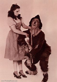 an old photo of two people dressed as scarecrows