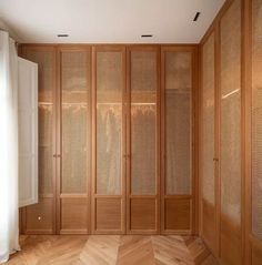 an empty room with wood paneling and glass doors