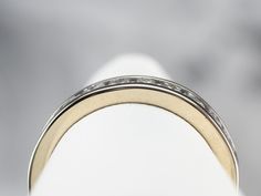 This 18 karat white gold diamond band has a classic design and shape, low domed profile, and simple row of channel-set diamonds! The diamonds are round cuts, which give the ring a lovely sparkle, capped off on each end by gleaming white gold. Metal: 18K White Gold Gem: 12 Diamonds totaling .85 Carats, H in Color, VS in Clarity Width of Band: 4.1 mm Height off Finger: 2.1 mm Ring Size: 6.50 Marks: "18KT" Stamped on the inside band Channel Set Diamond Ring With Round Band, Classic Eternity Band With Diamond Baguette Cut, Classic Eternity Band With Baguette Cut Diamond Accents, Classic Diamond White Channel Set Eternity Band, Classic Diamond Ring With Channel Set, Classic Diamond White Eternity Band With Channel Set, Classic Diamond Ring With Channel Set Round Cut, Classic Channel Set Diamond White Eternity Band, Classic Round Cut Channel Set Diamond Ring