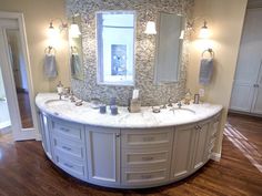 a large bathroom with two sinks and mirrors