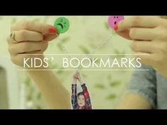 two people holding up some paper clips with faces on them and the words kids'bookmarks