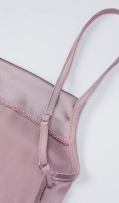 The features of this garment are reflected in the fabric and back design. The fabric is made from light silk, which is comfortable to the touch, breathable and sweat-absorbent, making it comfortable to wear while also highlighting high-end luxury. The back is designed with a silk waistband with cut-outs and a bow, which reveals a superior boned shape and highlights the slender, powerful appeal of the woman. The bow tie design at the waist adds style to the skirt, adding a more stylised flavour w Feminine Pink Dresses With Built-in Bra, Pink Satin Spaghetti Strap Dress, Chic Pink Slip Dress With Tie Back, Pink Stretch Slip Dress With Spaghetti Straps, Pink Fitted Slip Dress With Delicate Straps, Summer Satin Finish Camisole Dress, Pink Satin Dress With Adjustable Straps, Pink Satin Dresses With Adjustable Straps, Pink Satin Sleep Dress