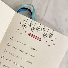 an open notebook with hearts on it