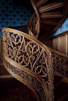 an intricate wooden spiral staircase in a building