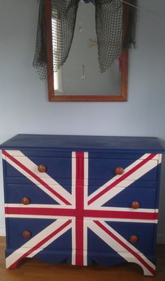 a blue dresser with a british flag painted on it