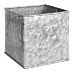 a square metal planter sitting on top of a white floor