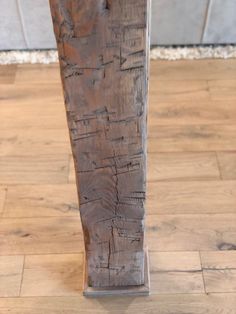 a piece of wood that has been carved into a vase on top of a wooden floor