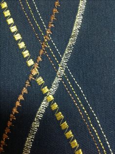 closeup of the stitchs on an old pair of jeans that have been sewn together