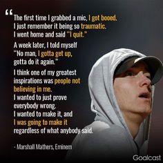 a man in a hoodie talking on a cell phone with a quote from marshall mathers