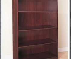 an empty bookcase in the corner of a room