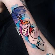 a person with a tattoo on their arm has an umbrella and pig in the rain