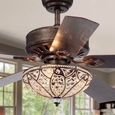 a ceiling fan with a chandelier hanging from it