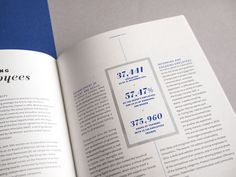 an open book with numbers and statistics on the page in blue, white and grey