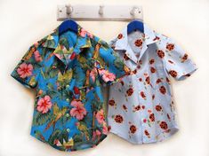 two children's shirts hanging on a clothes rack next to each other with flowers and ladybugs all over them