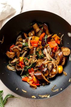 stir fried vegetables in a wok on a table