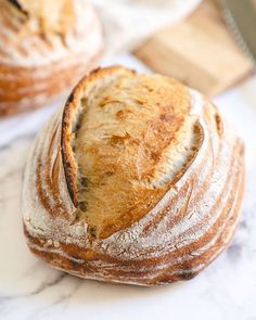 two loaves of bread sitting on top of a counter