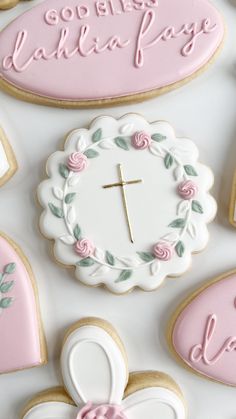 cookies decorated with pink and white icing are arranged around a clock