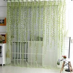 a living room with white walls and green curtains