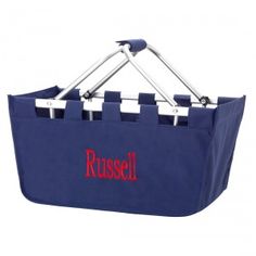 a blue shopping basket with the word russell written on it and two handles in pink