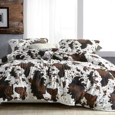 the comforter is made up with brown and white cow prints