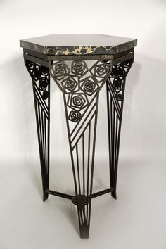 an art deco console table with black iron and marble top, circa 1920's