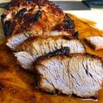 slices of meat sitting on top of a cutting board