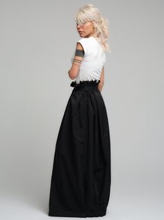 Make a bold statement with our high-waist skirt, the epitome of tailored elegance. This skirt is fashioned from premium polyester, delivering a smooth finish with a substantial feel that gracefully flows with every step. The design is accentuated by a tasteful belt that cinches the waist, while the elasticated back ensures a snug and comfortable fit. Its voluminous silhouette and sleek lines make it a versatile piece for both office wear and evening affairs. FEATURES:Includes a chic belt, elasticated back for comfort, and a high-waist cut 100% Handmade. SIZE & FIT: Fit: A relaxed fit with room to moveModel is wearing size Small or S/M View our SIZE CHART before ordering MATERIALS & CARE: Content: Polyester Care: Dry cleaning only SHIPPING: Made to order, processing time is 15 working days High-waist Fitted Maxi Skirt For Formal Occasions, Chic Pleated Satin Skirt, Elegant Spring Maxi Skirt For Night Out, Fitted High Waist Maxi Skirt For Formal Occasions, Formal High Waist Fitted Maxi Skirt, Formal High-waist Fitted Maxi Skirt, Chic Spring Skirt With Wide Waistband, Summer Evening Skirt With Pleated Waist, Formal Summer Satin Maxi Skirt