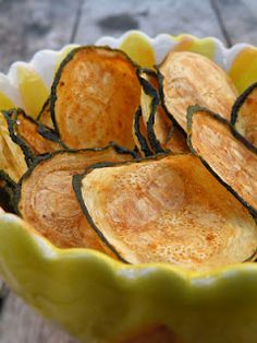 a yellow bowl filled with fried food on top of a wooden table